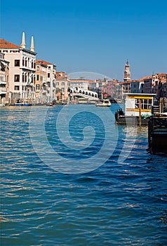 Bridge Rialto on Grand canal famous landmark panoramic view Venice Italy with blue sky white cloud and gondola boat water.