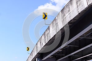 Bridge and right arrow sign with blue sky