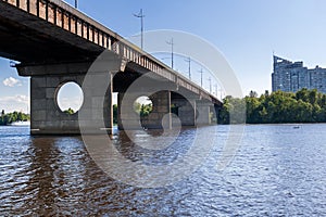 Bridge on a river against a blue sky and clouds