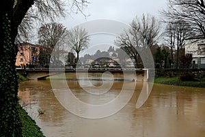 Bridge and river called FIUME BACCHIGLIONE in Vicenza City in northern Italy during flood