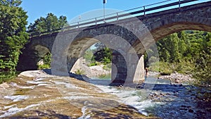 bridge river clear water old viaduct overpass car panning horizontal background