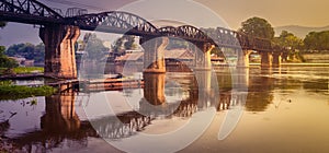 The bridge on the river Kwai at sunrise. Railway in Kanchanaburi, Thailand. Panorama