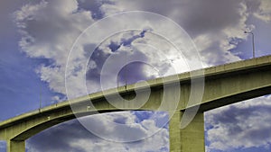 A bridge stretching across a dramatic sky