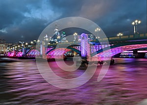 Bridge structure illuminated at night in London