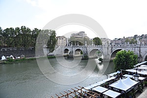 Bridge on Tiber river Rome Italian landscape city center and cafes