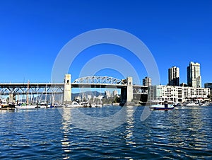 Bridge to greenville and water bus passing under the bridge Nature Canada Vancouver Pacific Ocean Pier and pillars on