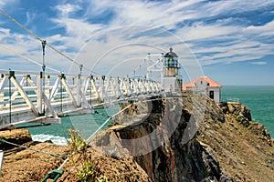 Bridge to Point Bonita Lighthouse outside San Francisco, California stands at the end of a beautiful suspension bridge. photo