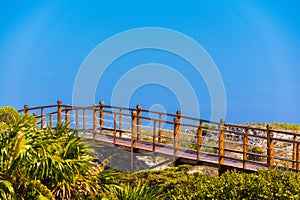 The bridge to the sandy beach Playa Paradise of the island of Cayo Largo, Cuba. Copy space for text. photo