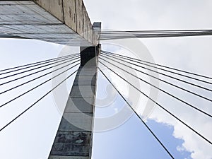 Bridge tower concrete columns with cable stays; Urban city transportation architecture structure, viewed from below.