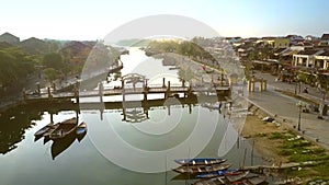 Bridge with traffic and boats moored by waterfront