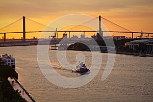 Bridge and Tugboat at Dusk