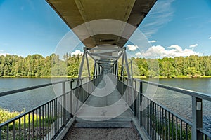 Bridge with underneath walking path crossing a river