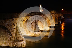 Bridge in Visegrad at night with lighting.