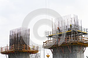 Bridge widening construction project: Workmen ties reinforcing bars