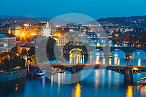 Bridges with historic Charles Bridge and Vltava river at night in Prague