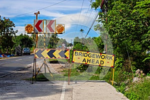 Bridgework ahead yellow sign on road construction site. South Asia economical development concept