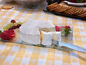 Brie cheese plate with strawberry and grapes