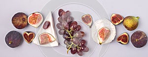 Brie Cheese Ripe Cut Figs Ripe Grape are Lying on Blue Background Food Background with Cheese and AutumnFruits Copy Space
