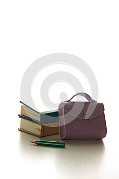 Brief-case, two books and a pencil  on white background. Education concept