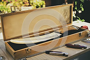 Briefcase with saber to uncork bottles of wine and champagne in the traditional style, through the system of the saber. Corkscrew