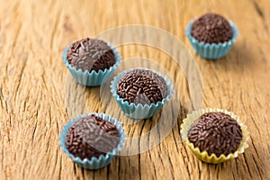 Brigadeiro is a chocolate truffle from Brazil. Cocoa and sprinkles of chocolate. Children birthday party sweet. Selective focus.