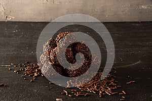 Brigadeiro (Brigadeiro) Traditional Brazilian sweet. Chocolate candies on dark background photo