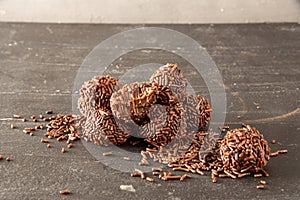 Brigadeiro (Brigadeiro) Traditional Brazilian sweet. Chocolate candies on dark background photo