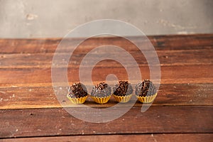 Brigadeiro (Brigadeiro) Traditional Brazilian sweet. Lined up on a wooden board photo