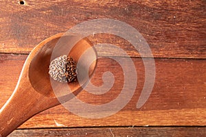 Brigadeiro in wooden spoon on wooden background photo