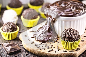 Brigadeiros or negrinhos, sweets typical of children`s birthday parties in Brazil, with chocolate around them. Brazilian cuisine photo