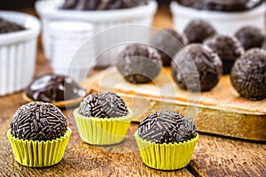 Brigadeiros or negrinhos, sweets typical of children`s birthday parties in Brazil, with chocolate around them. Brazilian cuisine photo