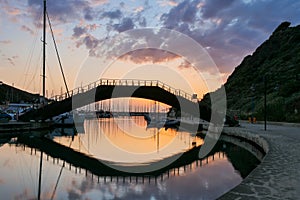 Brigde reflection in the water by sunset