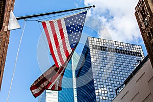 Bright american flag and the skyscrappers in a sunny weather photo