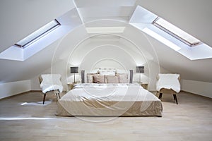 Bright attic bedroom in the apartment photo