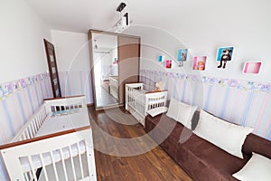 Bright baby room with white cradles