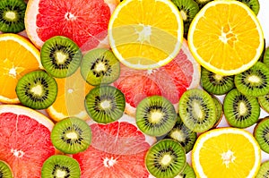 Bright background with kiwi fruit, grapefruit and oranges