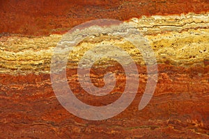 Bright background of natural stone in the colors of lush lava with a white stripe called Travertin Rosso