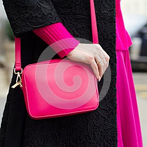 A bright bag in women`s hands. Leather bag.