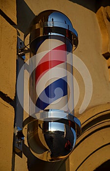 A bright banner for barbershop Montana allows barbers to be labeled and visible. The column consists of a backlit, rotating three-