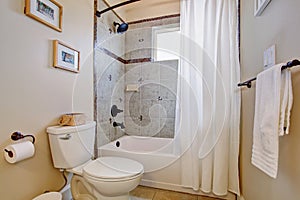 Bright bathroom nwith white shower curtain.