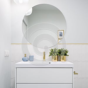 Bright bathroom with round mirror photo