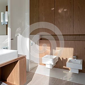 Bright bathroom with square toilet and bidet