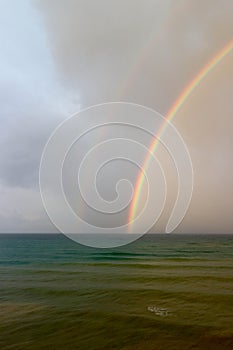 Bright beautiful colorful double rainbow over the sea