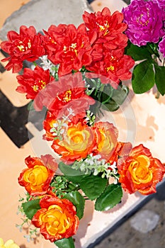 Bright and beautiful colors of plastic flowers. Various color flower background wall. Floral background. Lot of artificial flowers