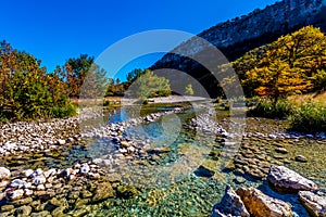 Bright Beautiful Fall Foliage on the Crystal Clear Frio River in Texas.