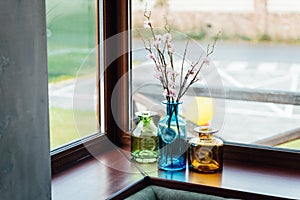 Bright beautiful flowers in a vase on the window