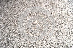 Bright beige wool fabric carpet or rug background texture close-up