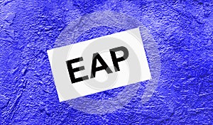 On a bright blue abstract background, there is a white card with the text EAP Employee Assistance Program