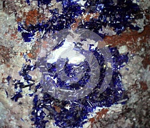 Bright blue azurite crystals in close up on matrix