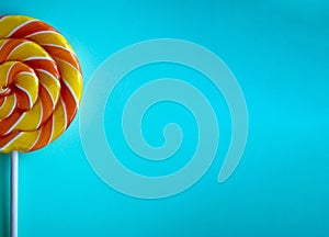 Bright blue background with half swirl lollipop with copy space